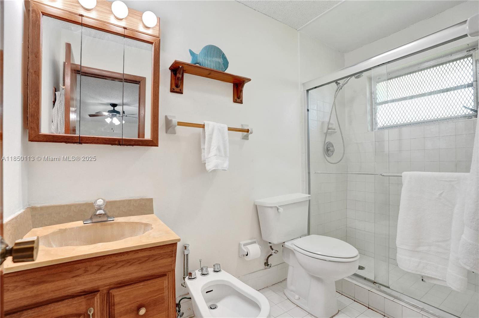 9461 Southwest 134th Street Miami, FL 33176 - Photo 23 of 33 a bathroom with a sink mirror vanity and toilet