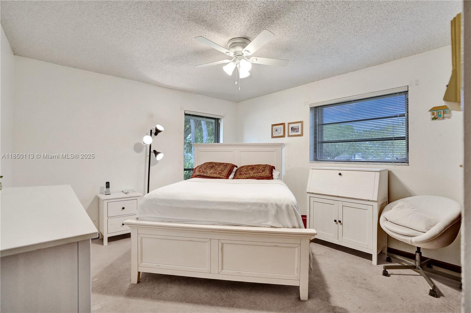 9461 Southwest 134th Street Miami, FL 33176 - Photo 26 of 33 a bedroom with a bed and a chandelier