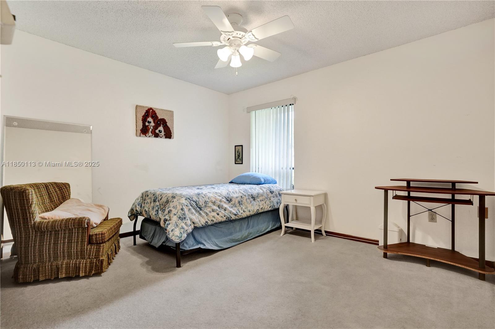 9461 Southwest 134th Street Miami, FL 33176 - Photo 27 of 33 a bedroom with a bed and a chandelier