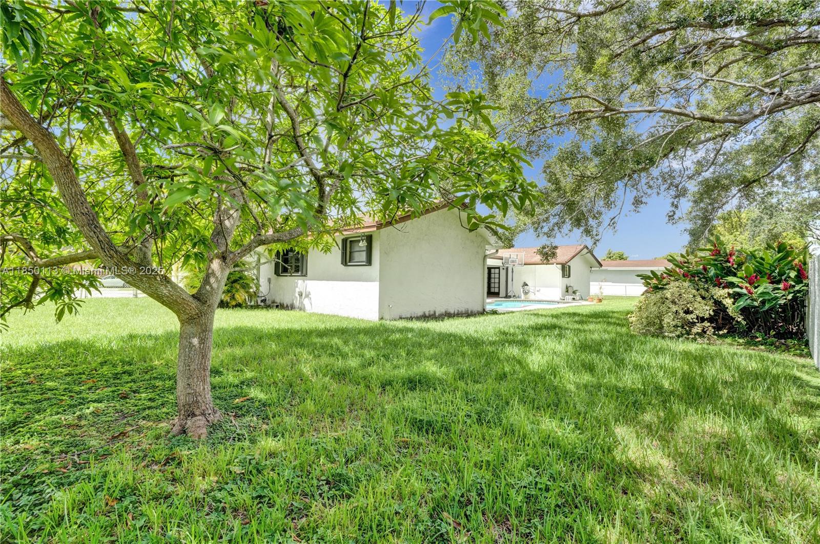 9461 Southwest 134th Street Miami, FL 33176 - Photo 3 of 33 a fire hydrant in the middle of a field