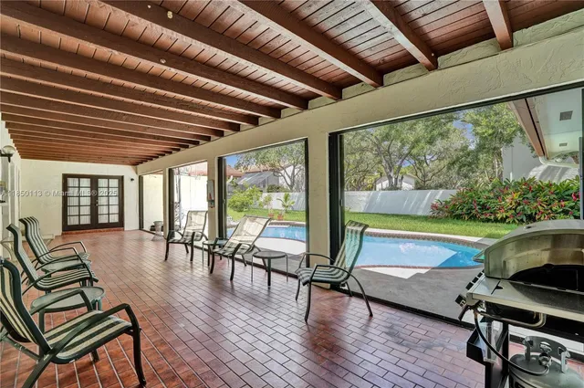 a view of a patio with swimming pool table and chairs