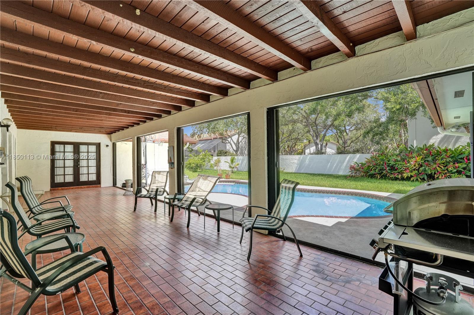 9461 Southwest 134th Street Miami, FL 33176 - Photo 4 of 33 a view of a patio with swimming pool table and chairs