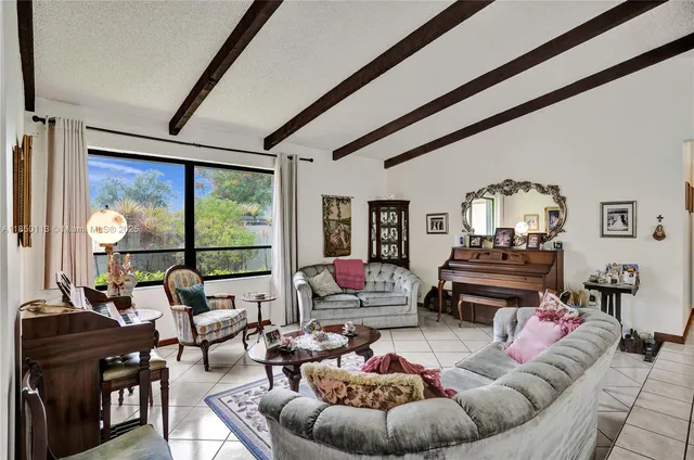 a living room with furniture and a floor to ceiling window