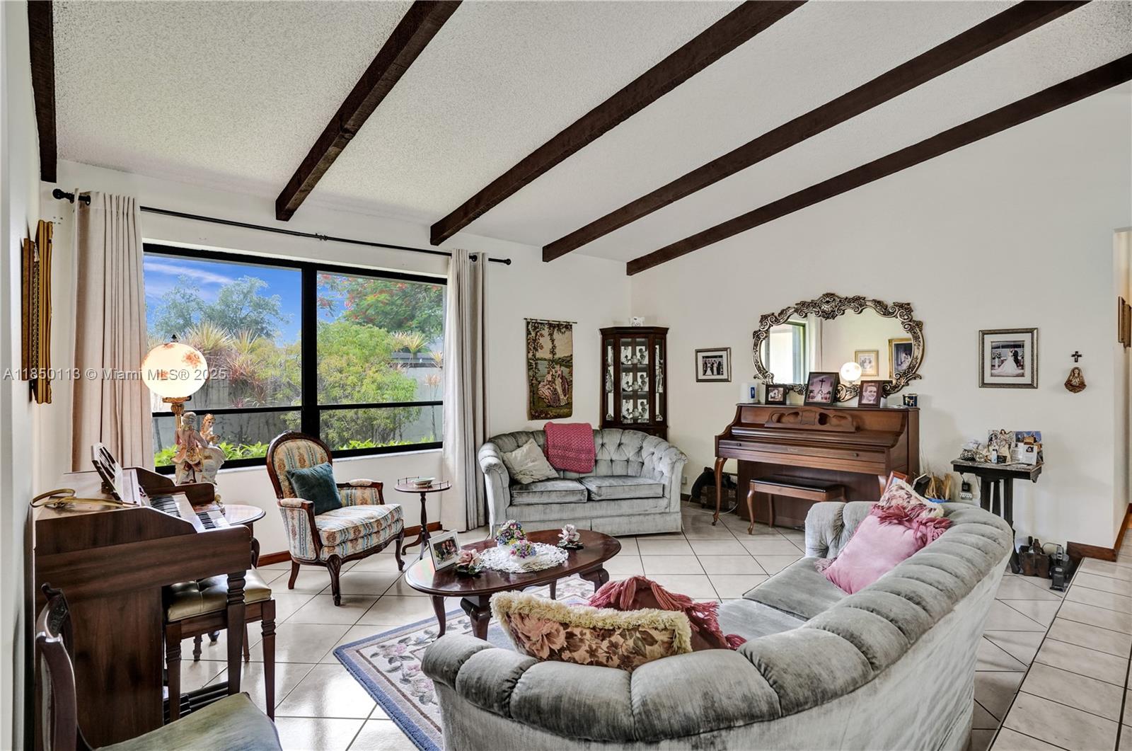 9461 Southwest 134th Street Miami, FL 33176 - Photo 6 of 33 a living room with furniture and a floor to ceiling window