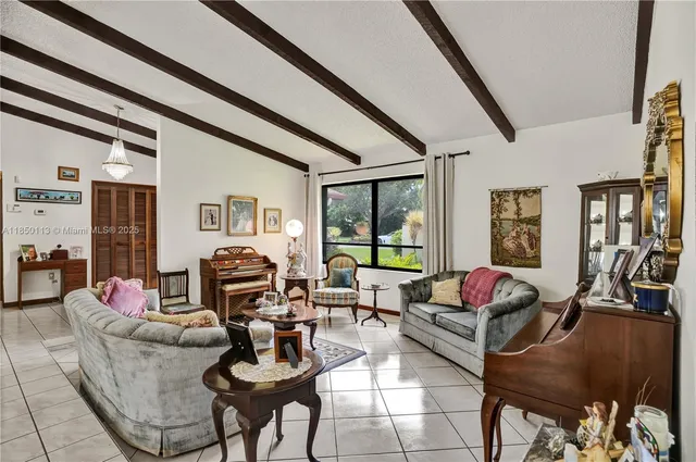 a living room with furniture and floor to ceiling windows