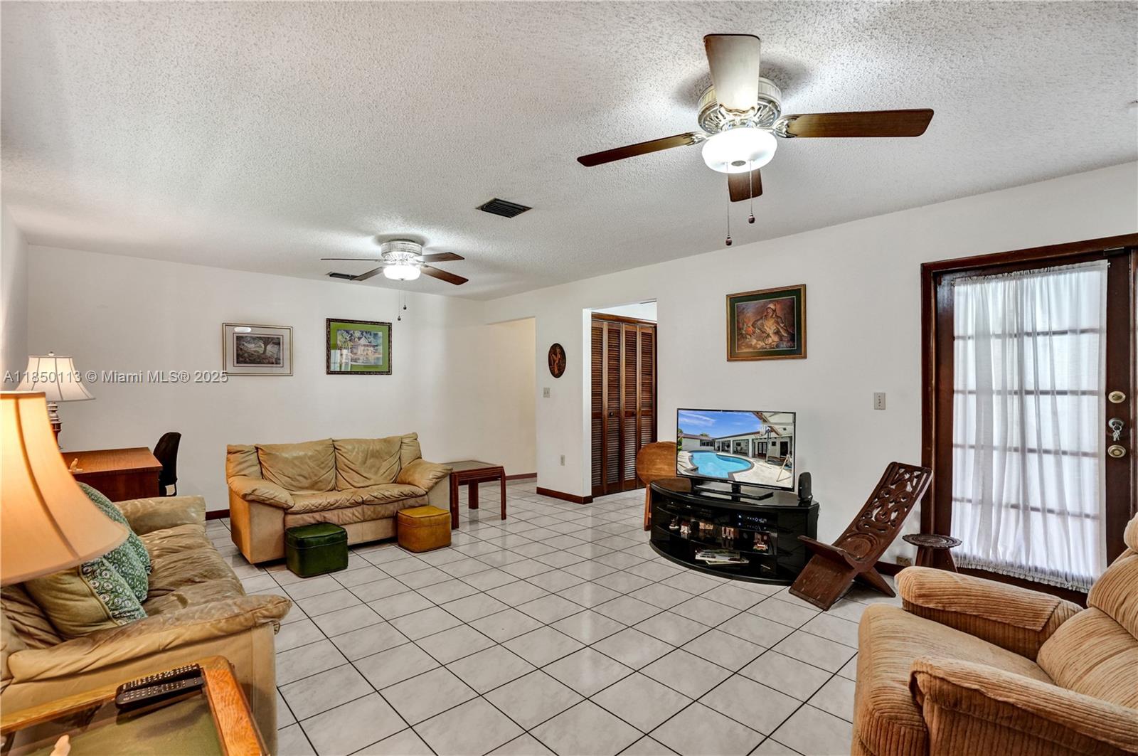 9461 Southwest 134th Street Miami, FL 33176 - Photo 8 of 33 a living room with furniture