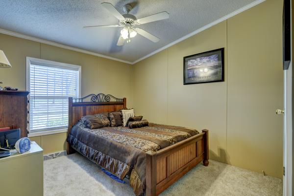 4339 South Garrett Road Springfield, TN 37172 - Photo 16 of 28 a bedroom with a bed and a chandelier