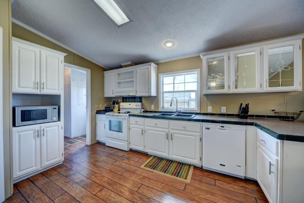 4339 South Garrett Road Springfield, TN 37172 - Photo 6 of 28 a kitchen with granite countertop white cabinets and white appliances