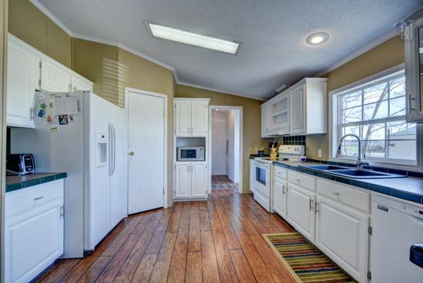4339 South Garrett Road Springfield, TN 37172 - Photo 8 of 28 a large kitchen with cabinets wooden floor and stainless steel appliances