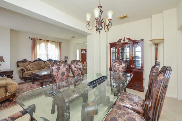 a living room with furniture chandelier and a chandelier