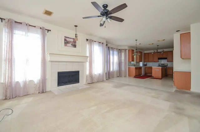 a view of a livingroom with a fireplace and a window