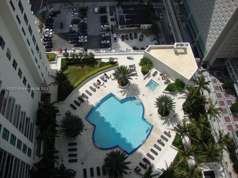an aerial view of a house with a swimming pool and chairs