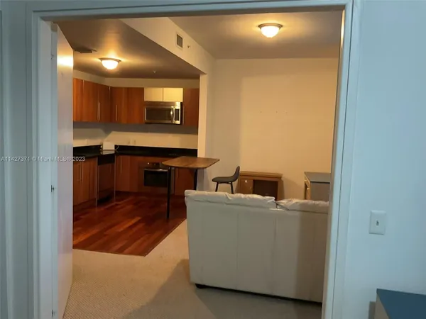 a room with wooden floor and furniture