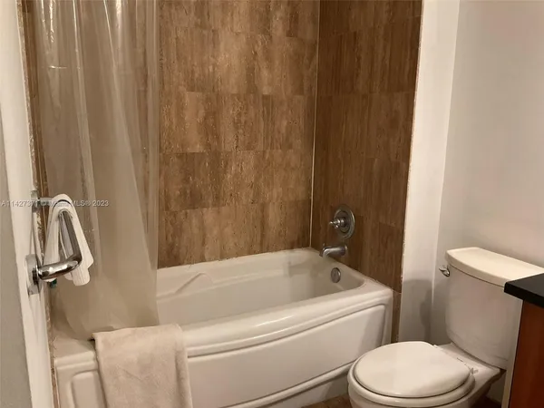 a bathroom with a toilet and a tub