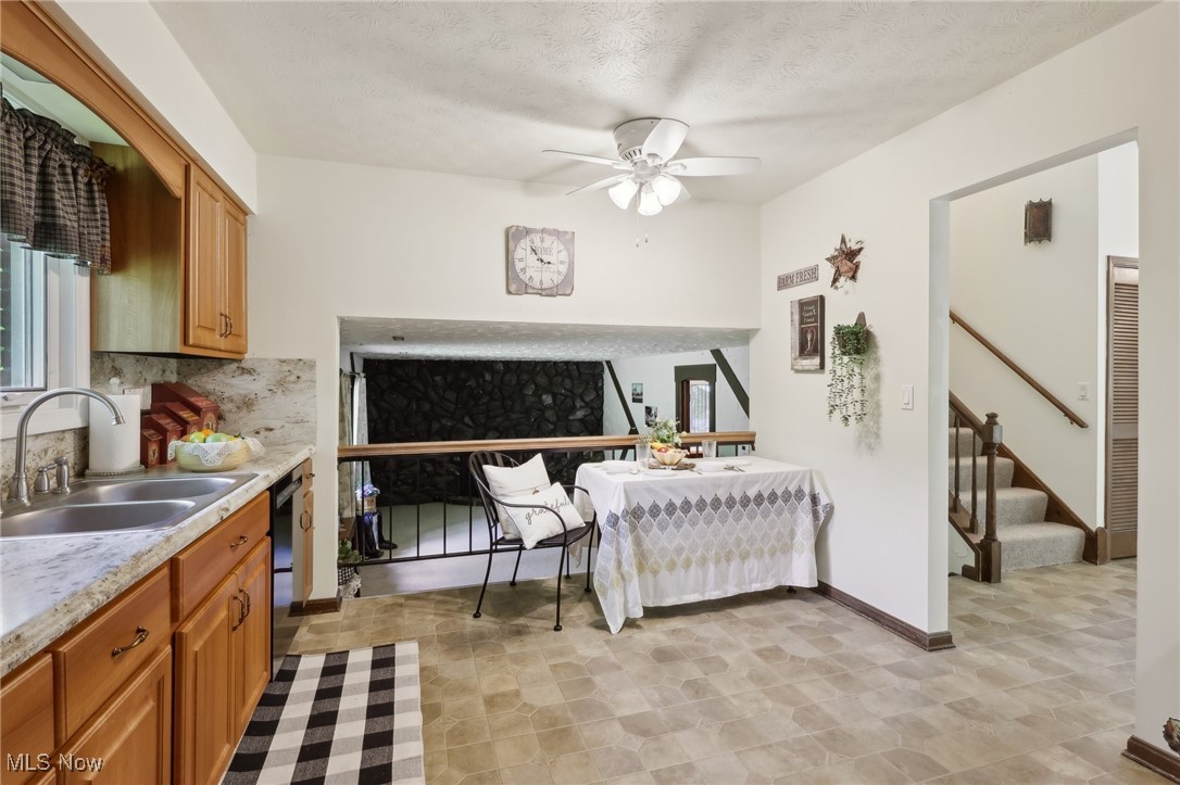 5845 Carsten Road Medina, OH 44256 - Photo 23 of 37 Kitchen featuring decorative backsplash, sink, dishwashing machine, ceiling fan, and light tile patterned flooring