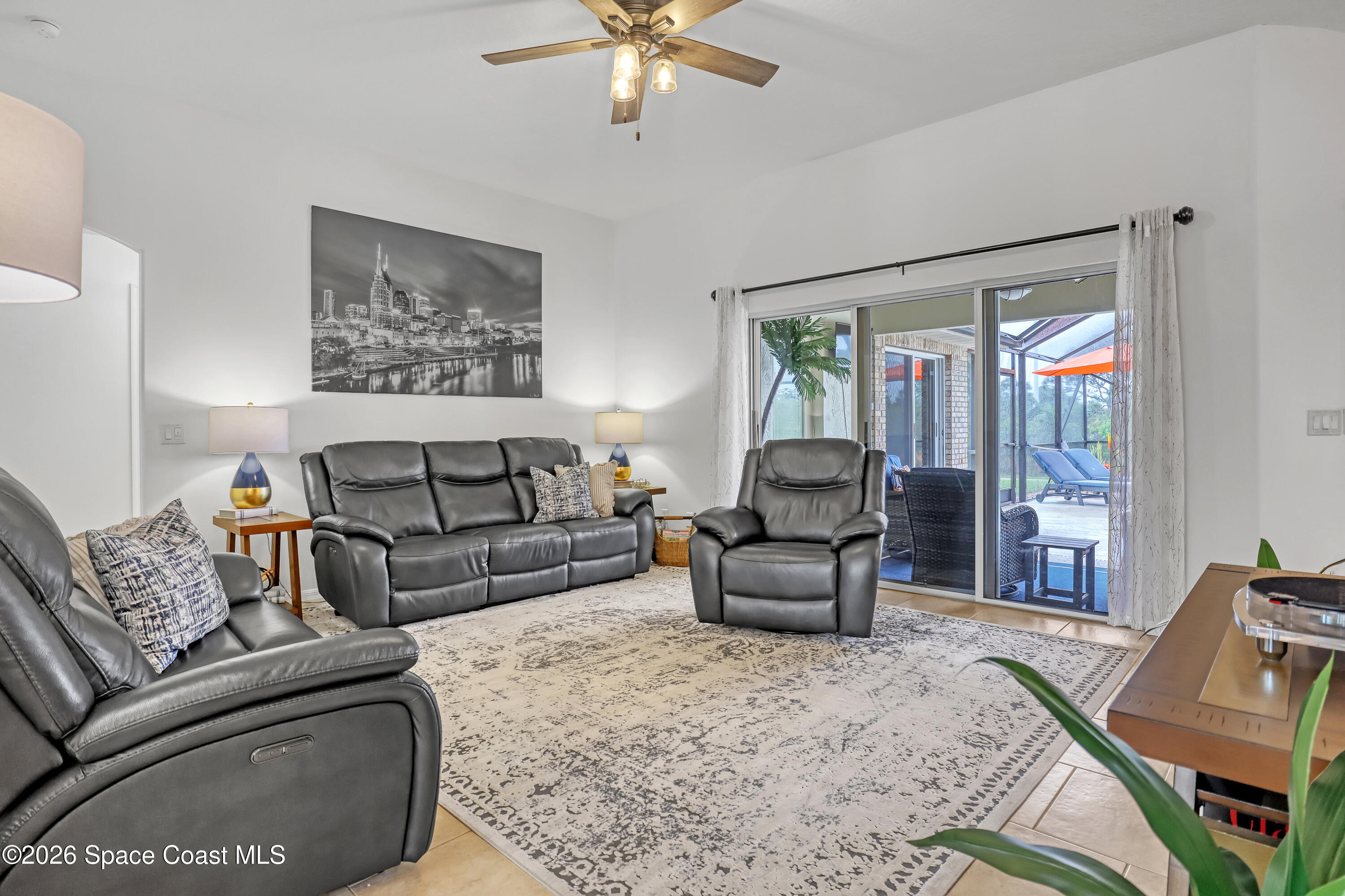 3120 Forest Creek Drive Melbourne, FL 32901 - Photo 12 of 59 a living room with furniture and a large window