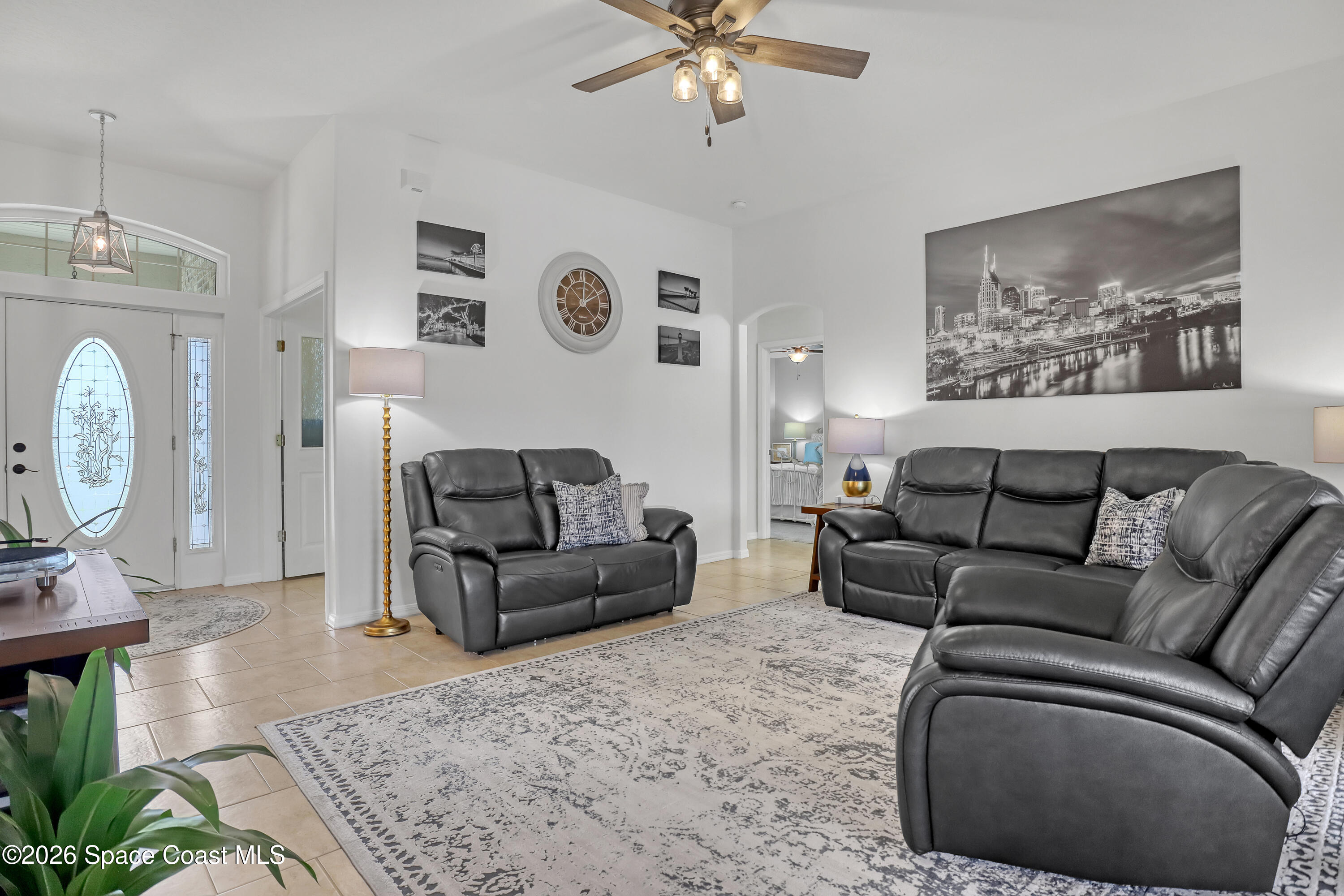 3120 Forest Creek Drive Melbourne, FL 32901 - Photo 13 of 59 a living room with furniture and a chandelier