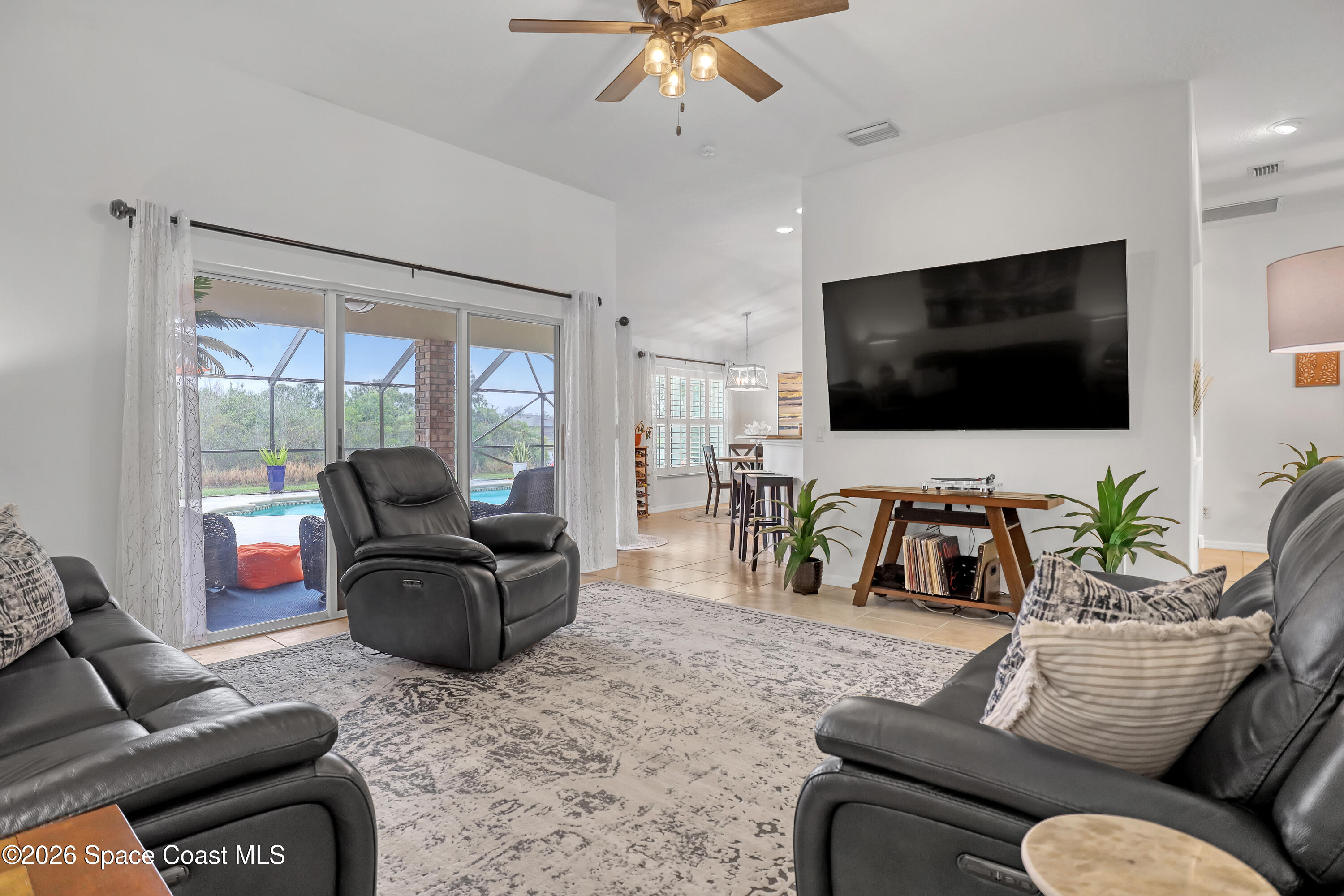 3120 Forest Creek Drive Melbourne, FL 32901 - Photo 14 of 59 a living room with furniture and a flat screen tv
