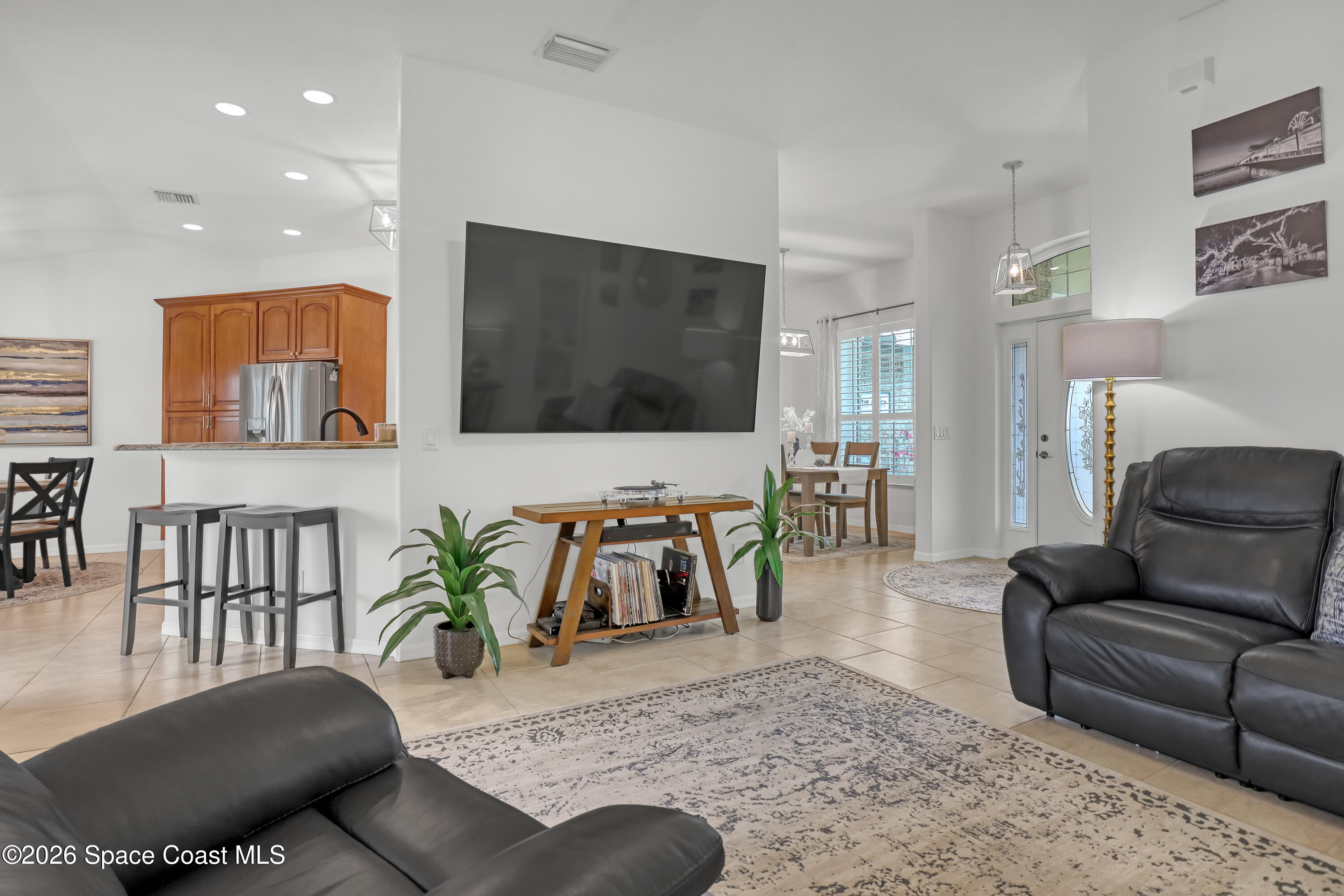 3120 Forest Creek Drive Melbourne, FL 32901 - Photo 15 of 59 a living room with furniture and a flat screen tv
