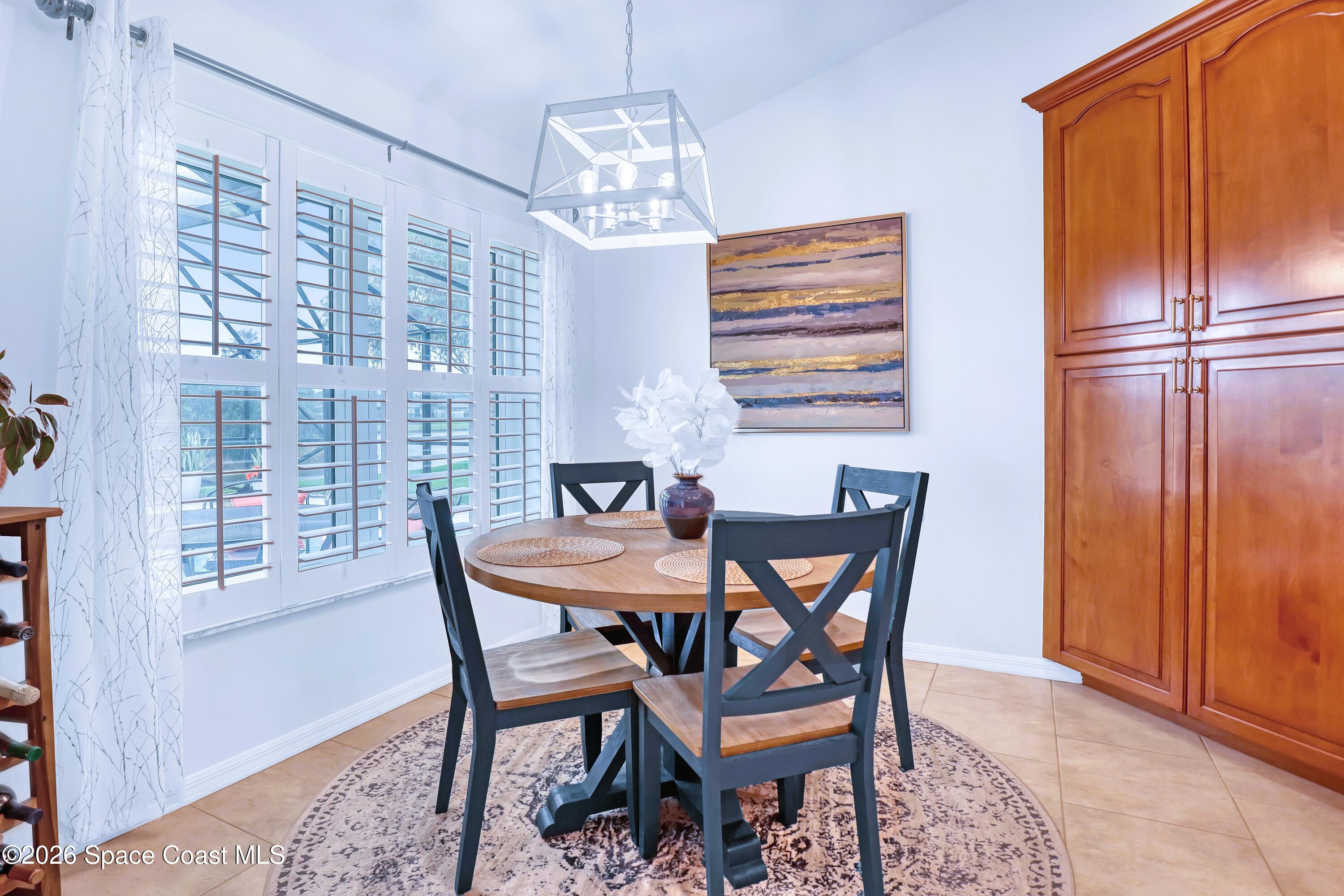 3120 Forest Creek Drive Melbourne, FL 32901 - Photo 19 of 59 a dining room with furniture and window