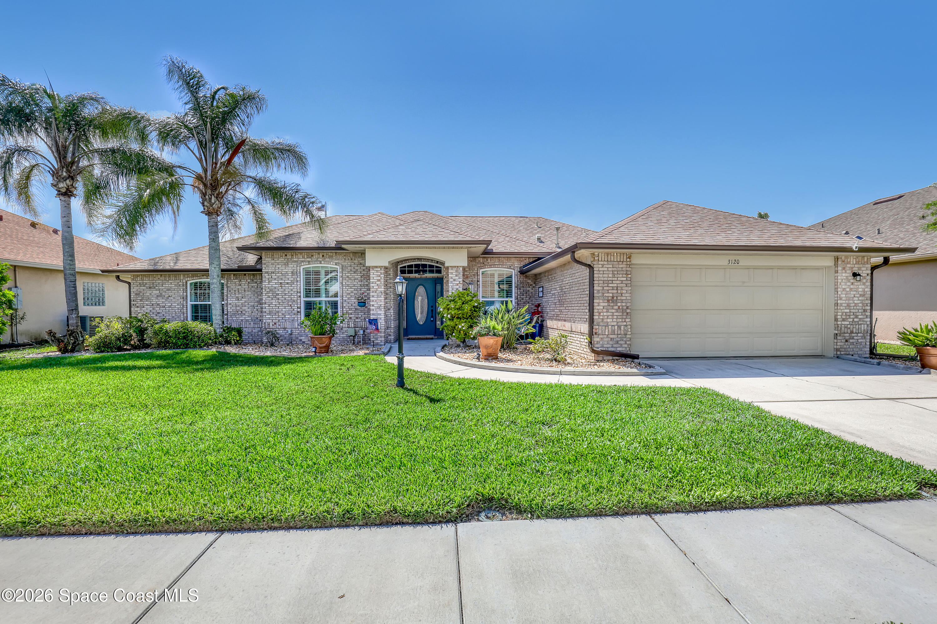 3120 Forest Creek Drive Melbourne, FL 32901 - Photo 2 of 59 a view of house with a garden