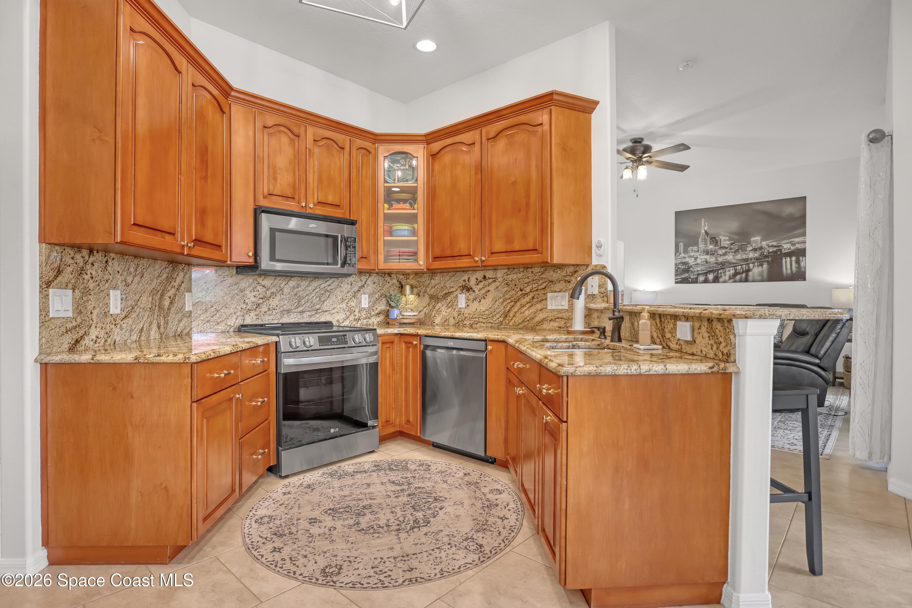 3120 Forest Creek Drive Melbourne, FL 32901 - Photo 21 of 59 a kitchen with stainless steel appliances granite countertop a stove a sink dishwasher and a refrigerator