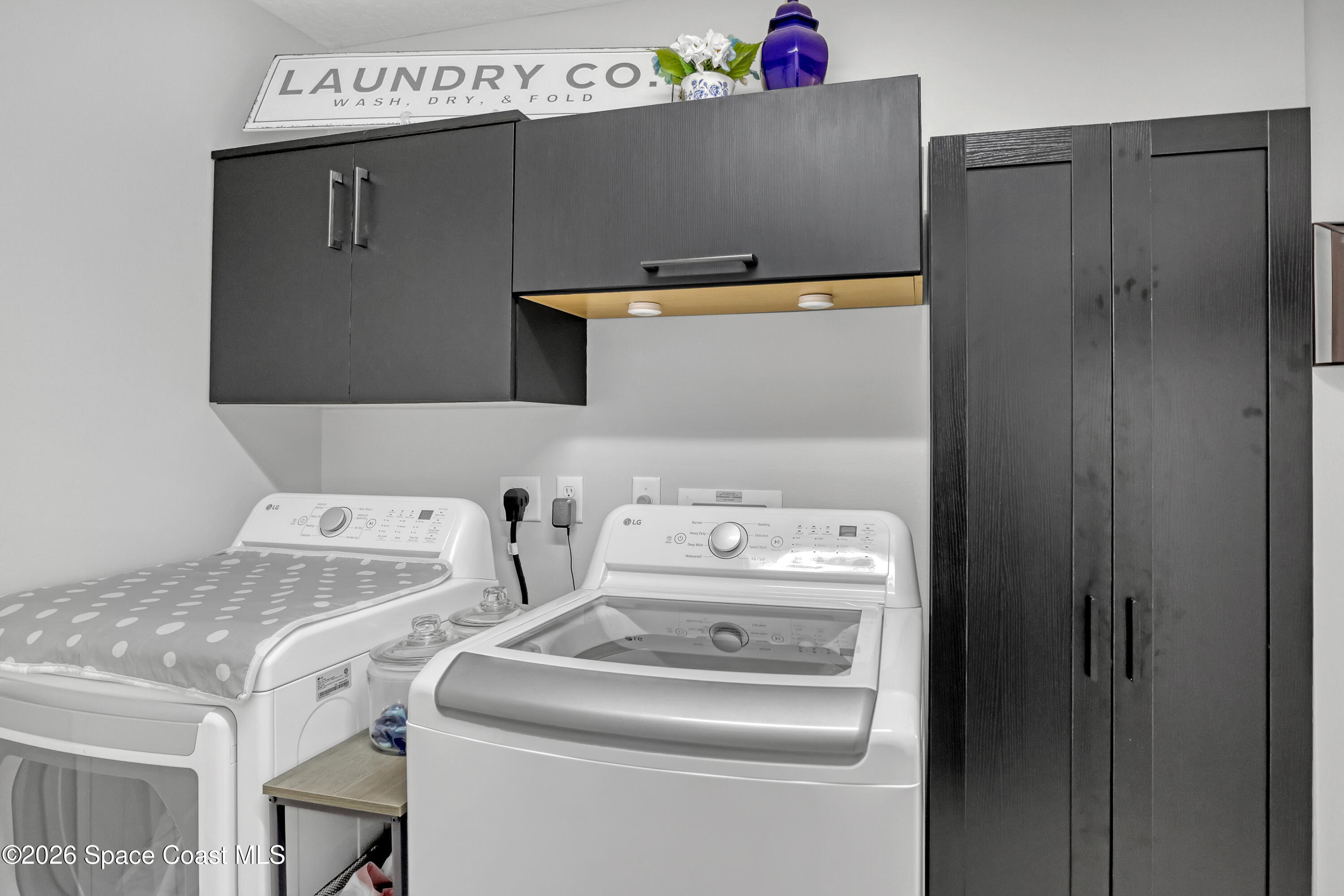 3120 Forest Creek Drive Melbourne, FL 32901 - Photo 23 of 59 a utility room with dryer and washer