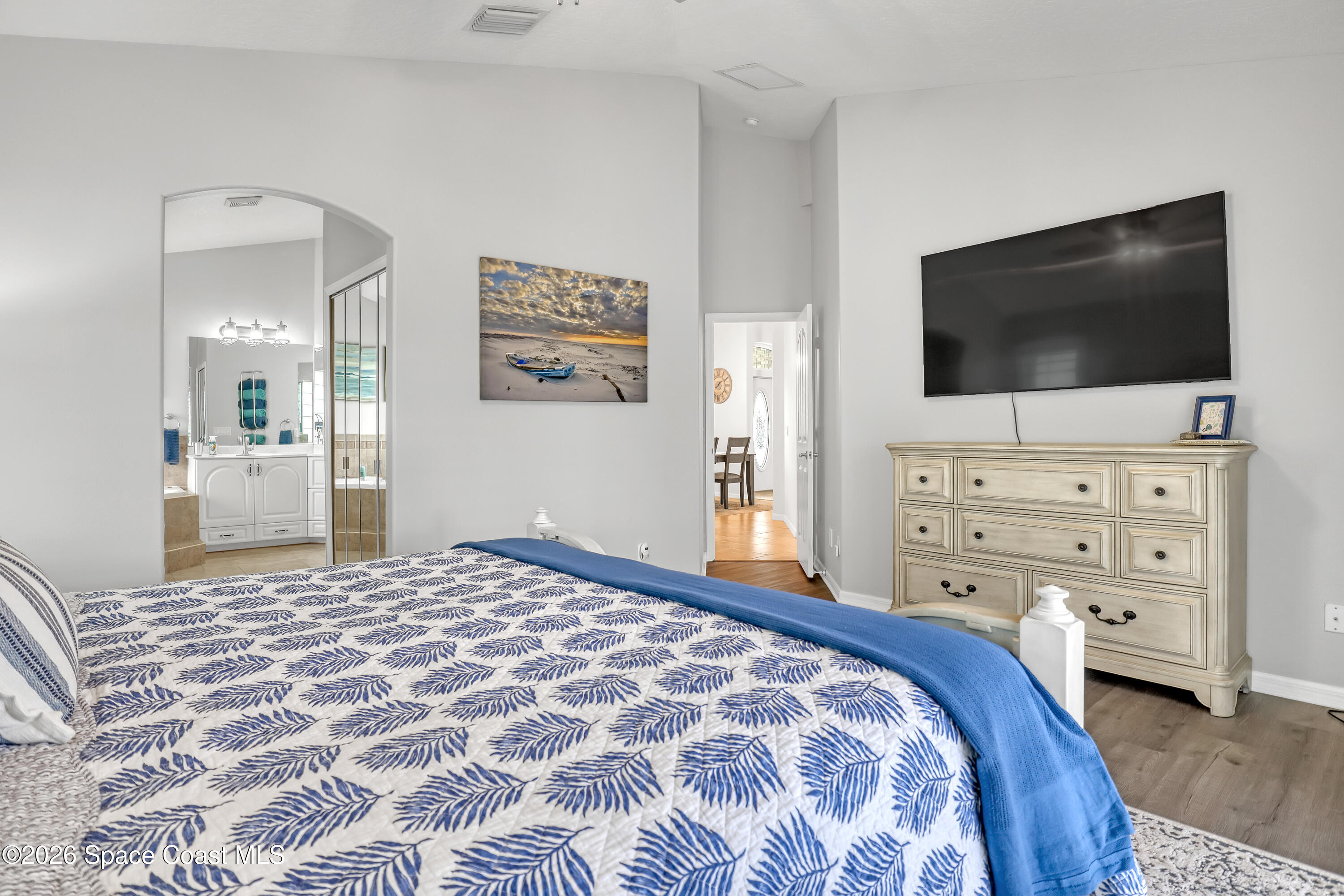 3120 Forest Creek Drive Melbourne, FL 32901 - Photo 25 of 59 a bedroom with a bed and a flat screen tv in it