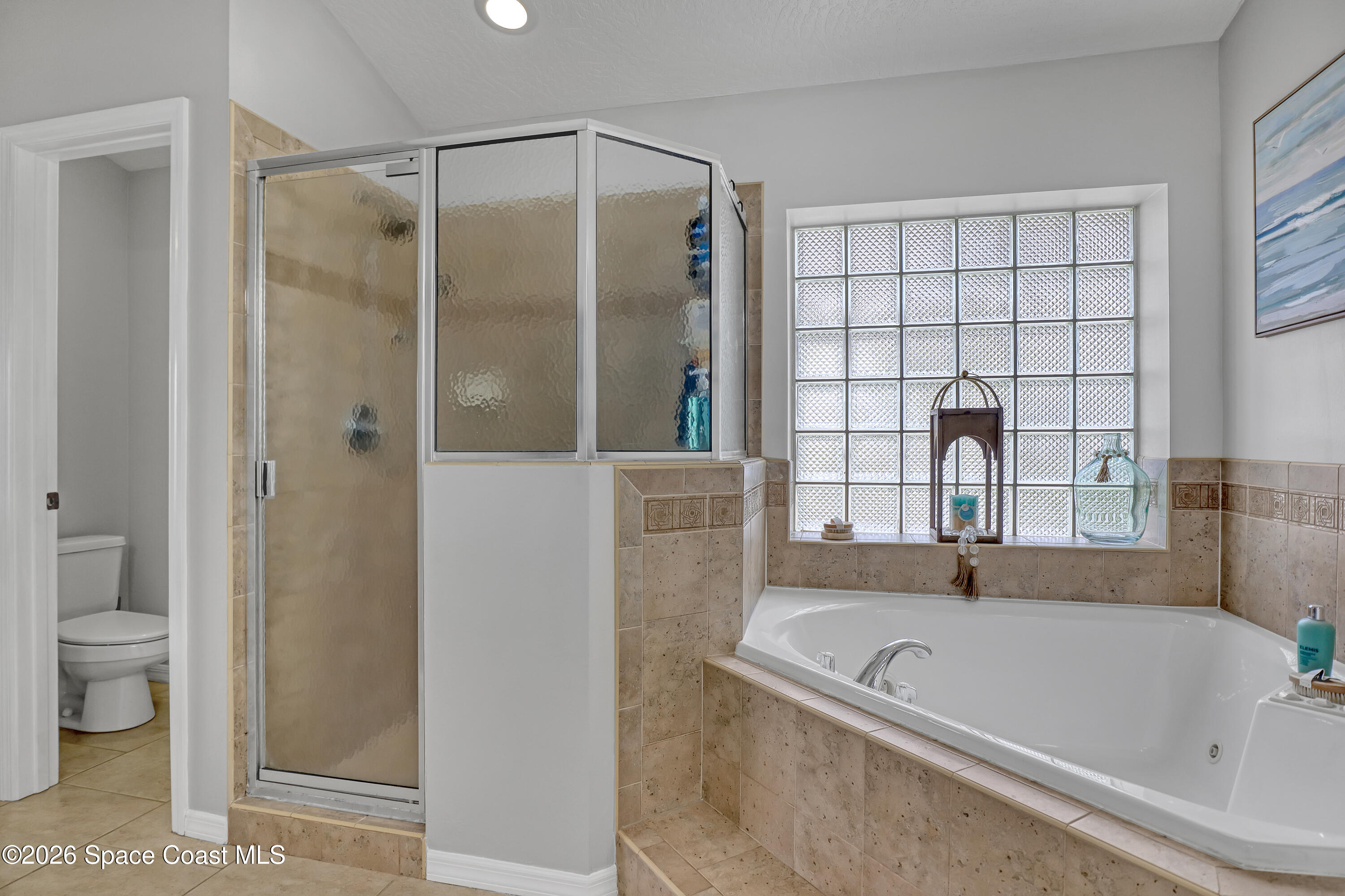 3120 Forest Creek Drive Melbourne, FL 32901 - Photo 30 of 59 a bathroom with a bathtub and a shower