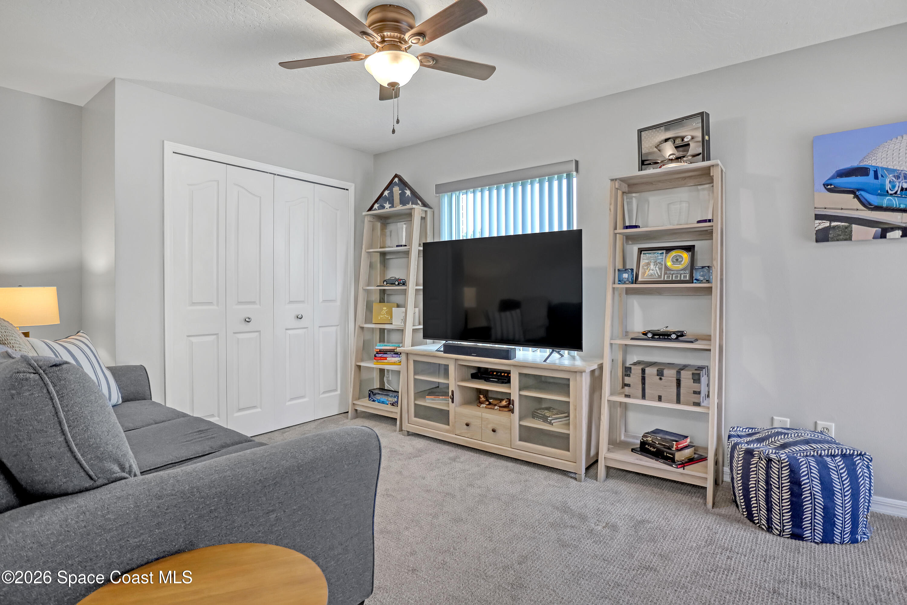 3120 Forest Creek Drive Melbourne, FL 32901 - Photo 36 of 59 a living room with furniture and a flat screen tv