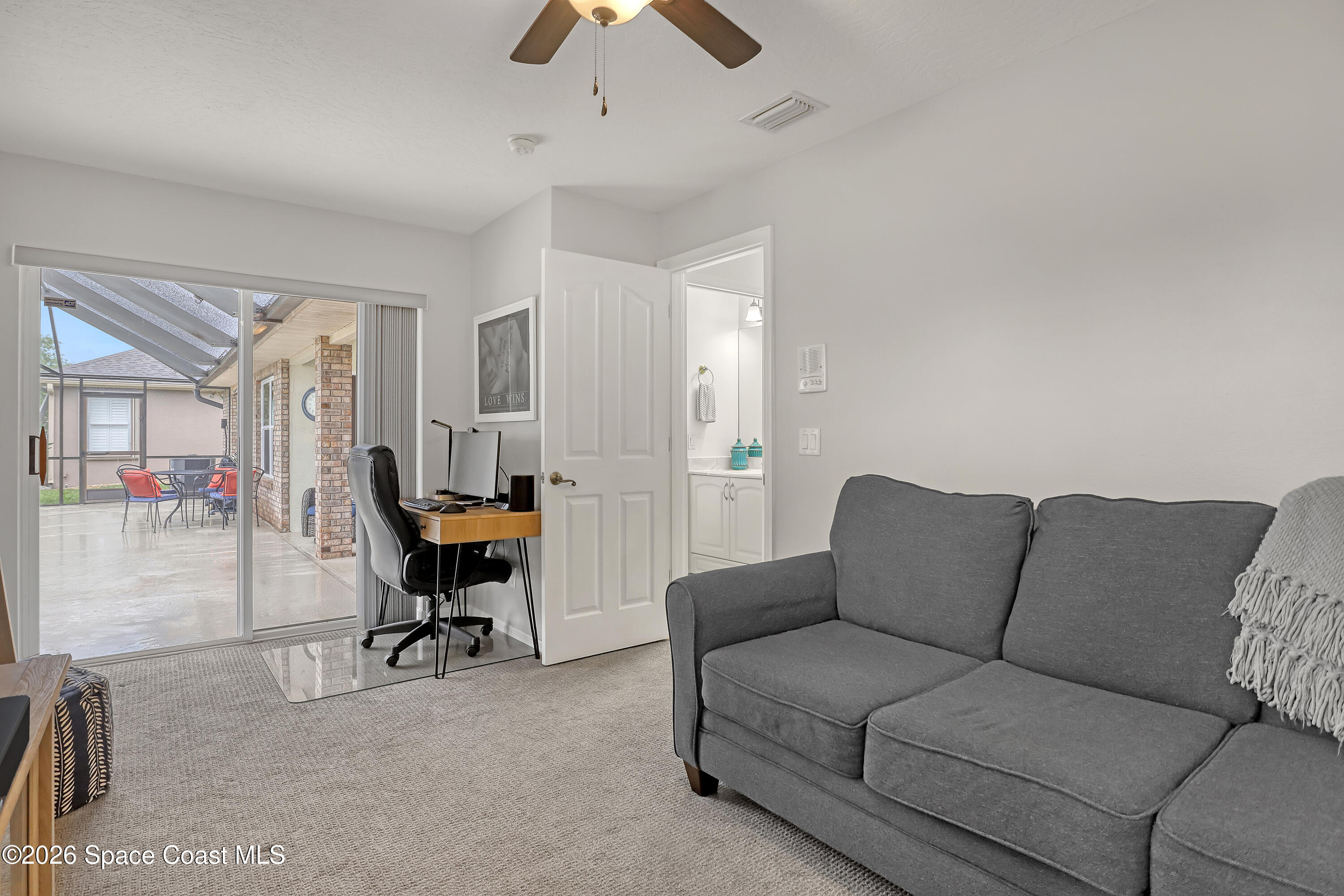 3120 Forest Creek Drive Melbourne, FL 32901 - Photo 37 of 59 a living room with furniture and a chandelier