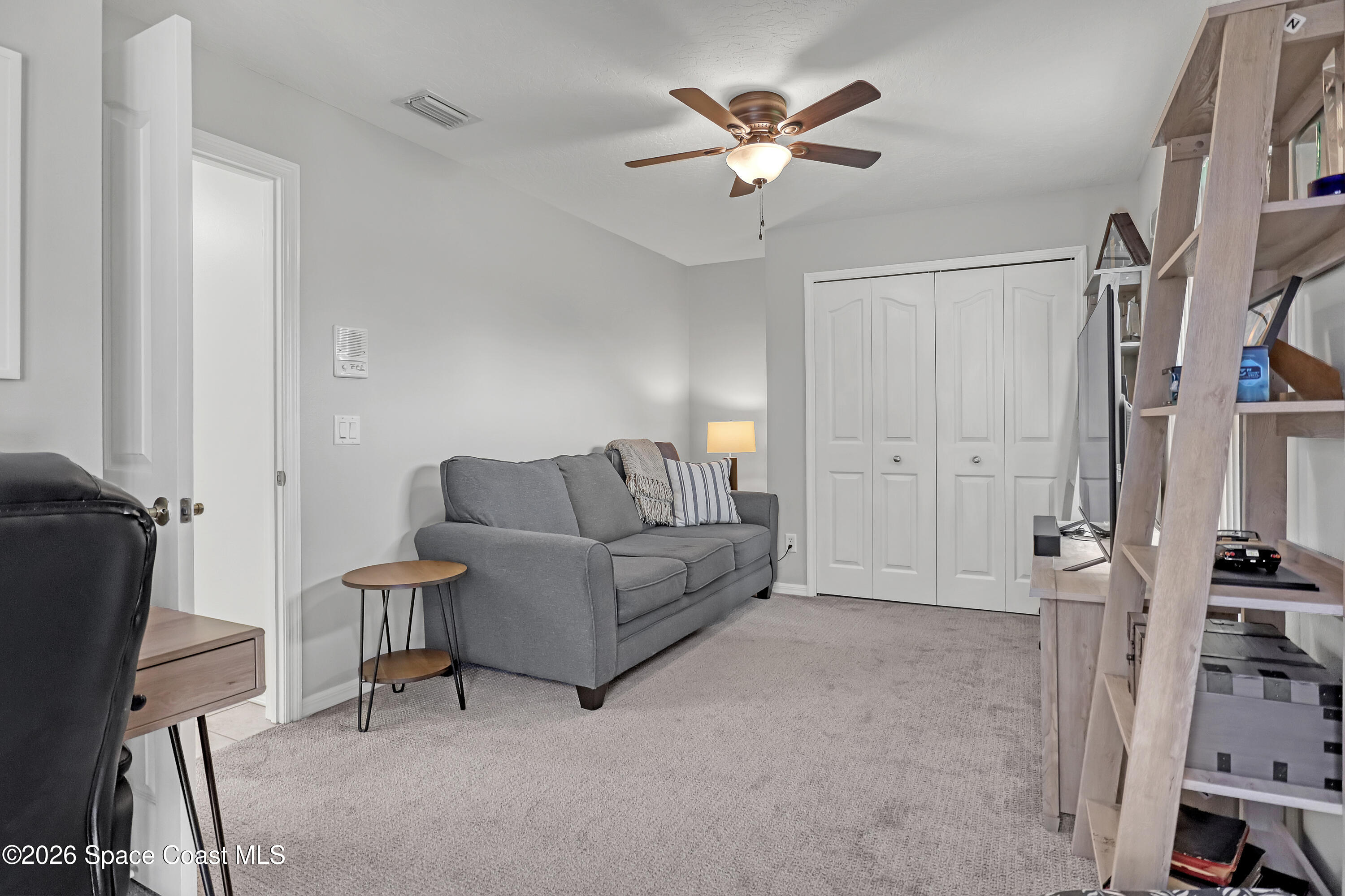 3120 Forest Creek Drive Melbourne, FL 32901 - Photo 39 of 59 a living room with furniture and a chandelier