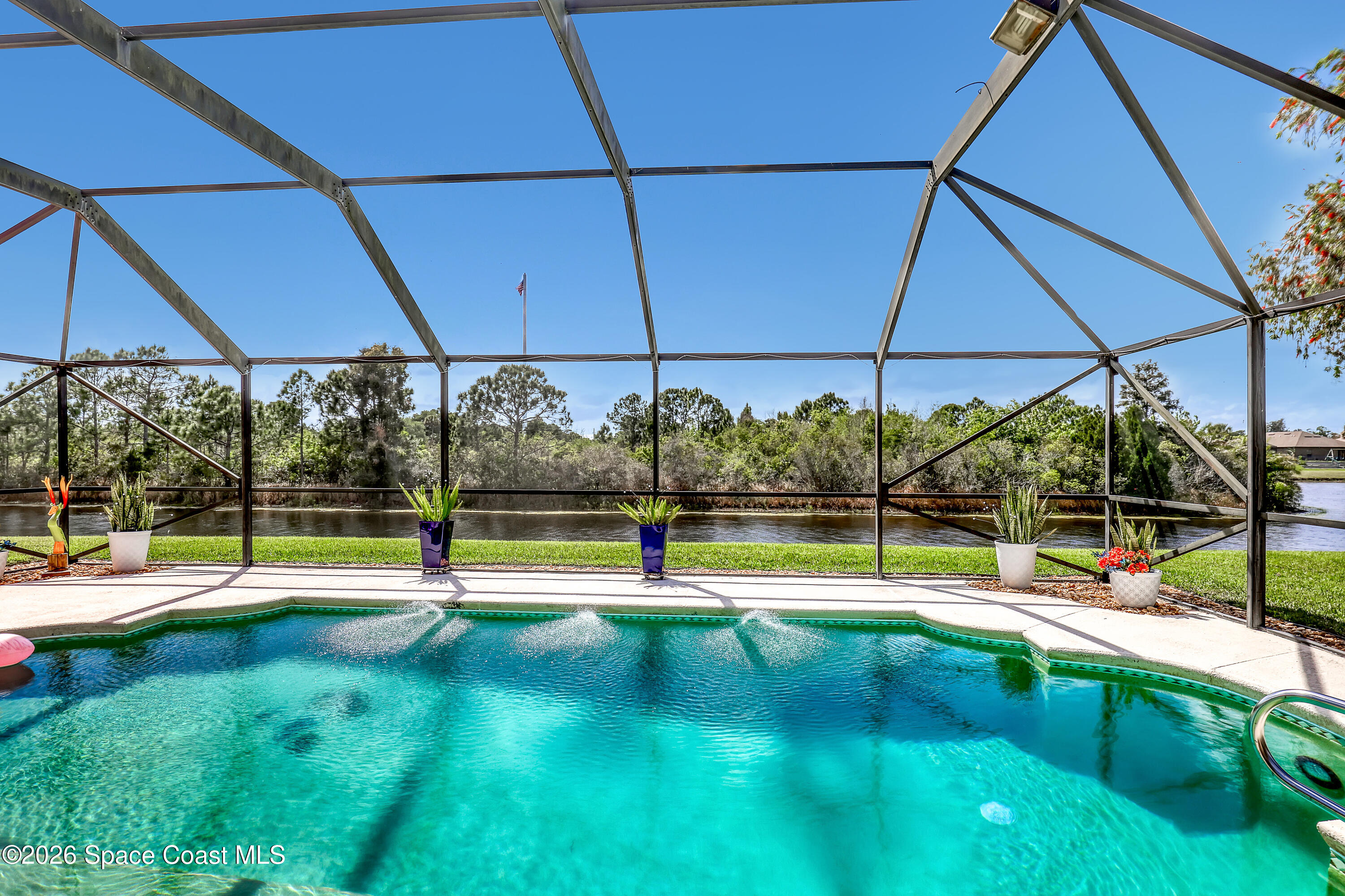 3120 Forest Creek Drive Melbourne, FL 32901 - Photo 4 of 59 a view of a swimming pool with a yard