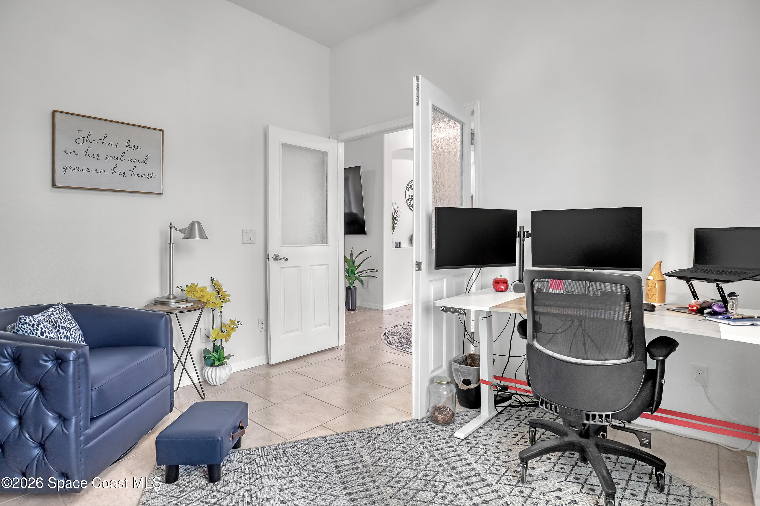 3120 Forest Creek Drive Melbourne, FL 32901 - Photo 43 of 59 a living room with a couch and a flat screen tv