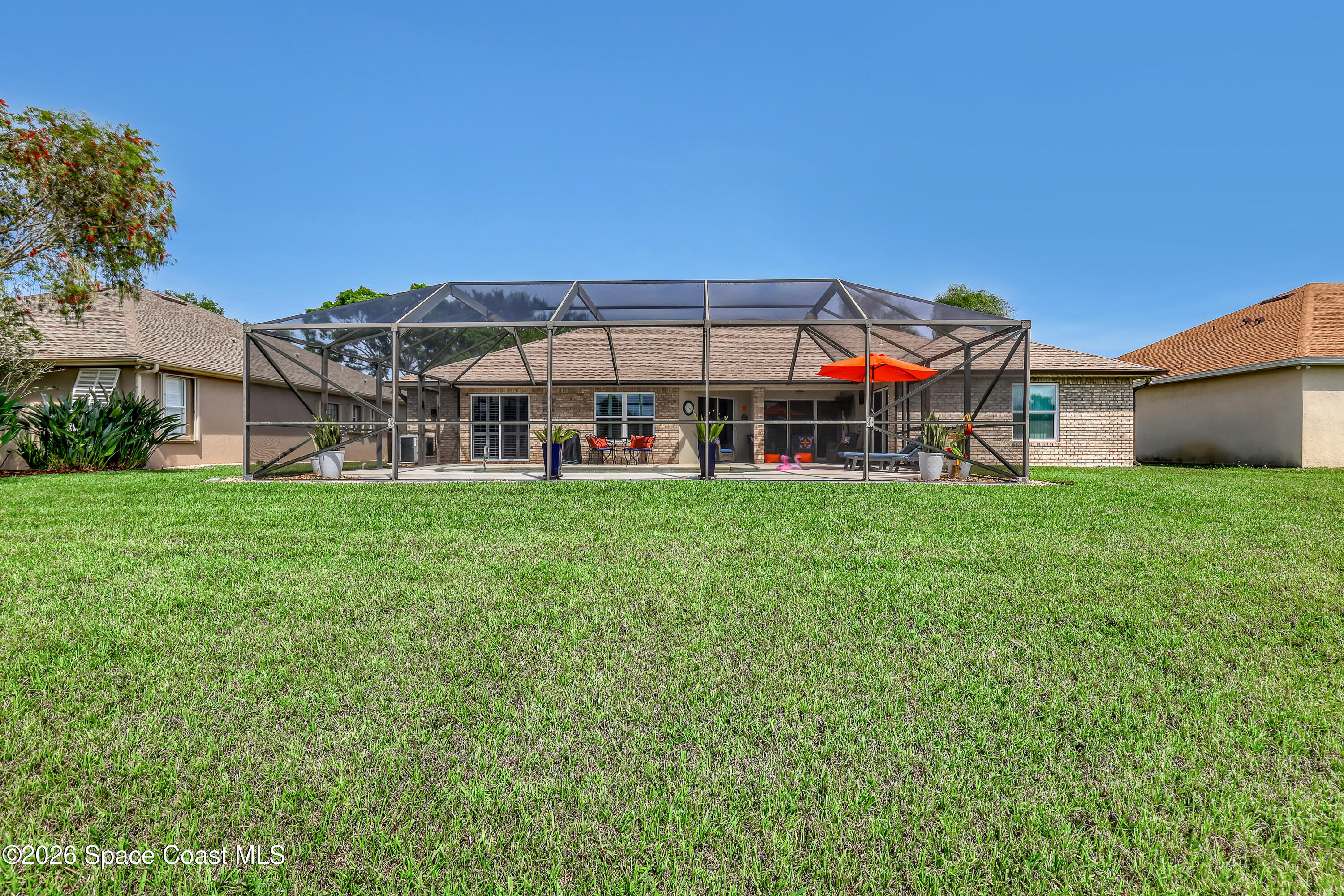 3120 Forest Creek Drive Melbourne, FL 32901 - Photo 48 of 59 a view of a house with a big yard and large trees