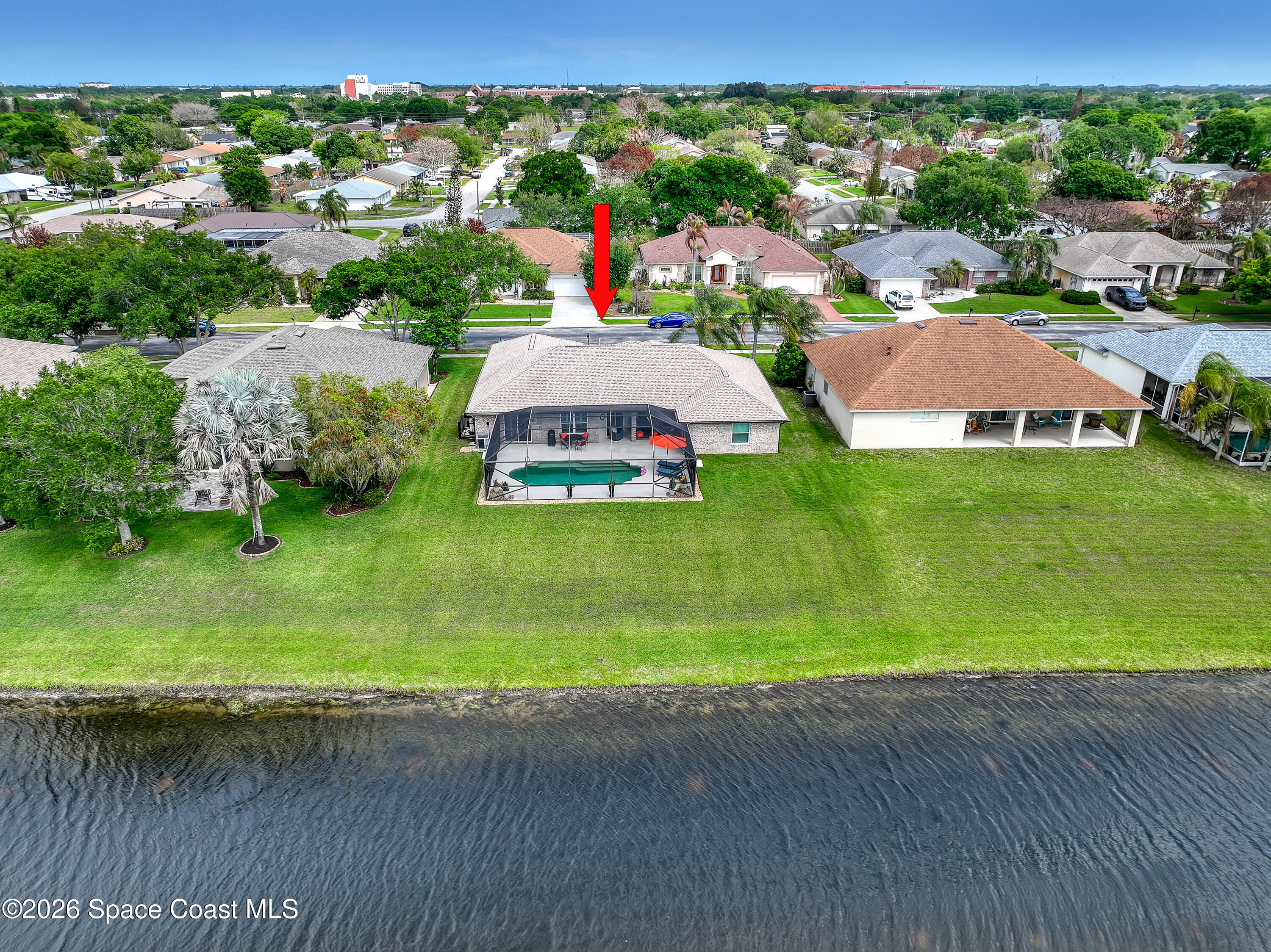 3120 Forest Creek Drive Melbourne, FL 32901 - Photo 58 of 59 an aerial view of a house with a garden and swimming pool