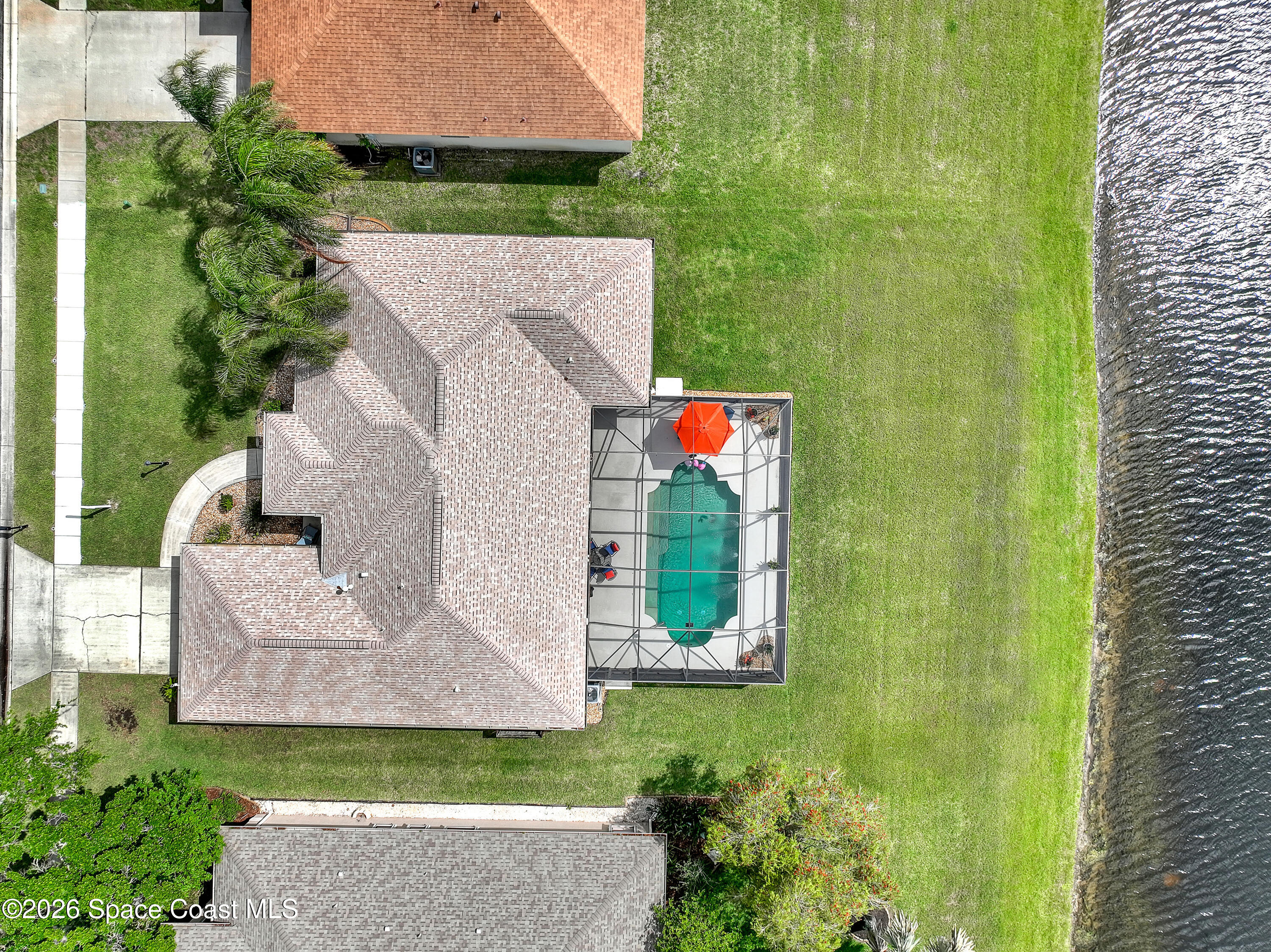 3120 Forest Creek Drive Melbourne, FL 32901 - Photo 59 of 59 an aerial view of a house with a garden and trees