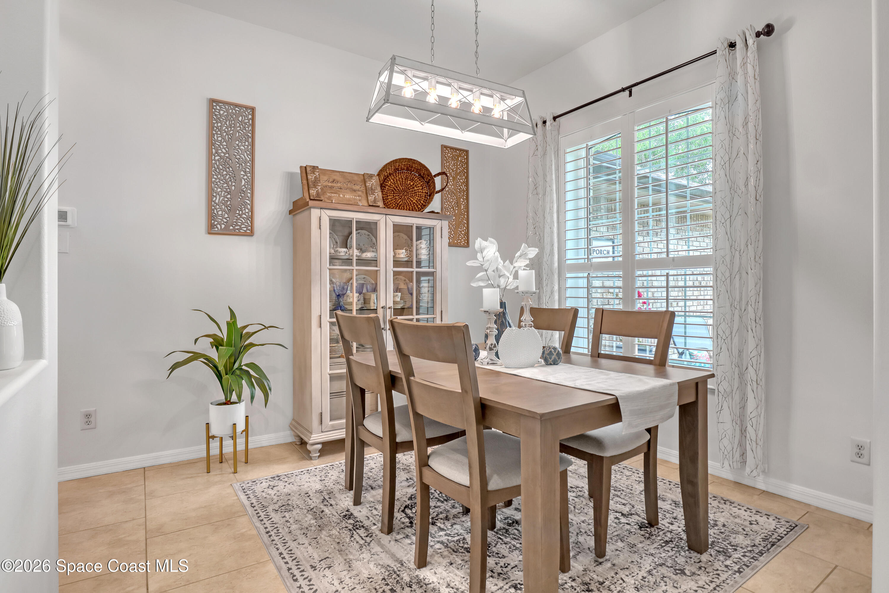 3120 Forest Creek Drive Melbourne, FL 32901 - Photo 9 of 59 a dining room with furniture and window