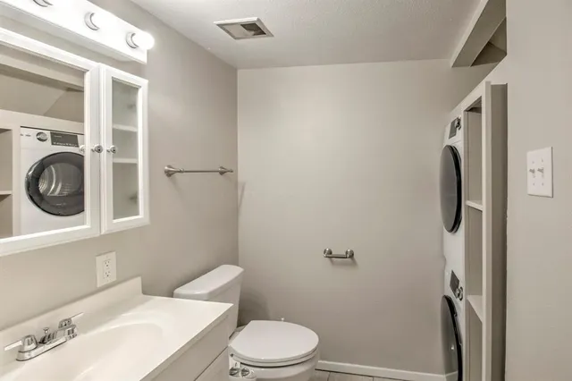 a white toilet sitting next to a bathroom sink