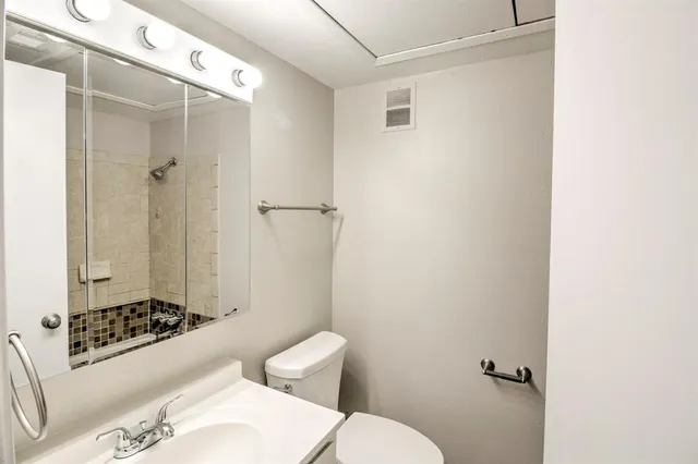a bathroom with a sink toilet and shower