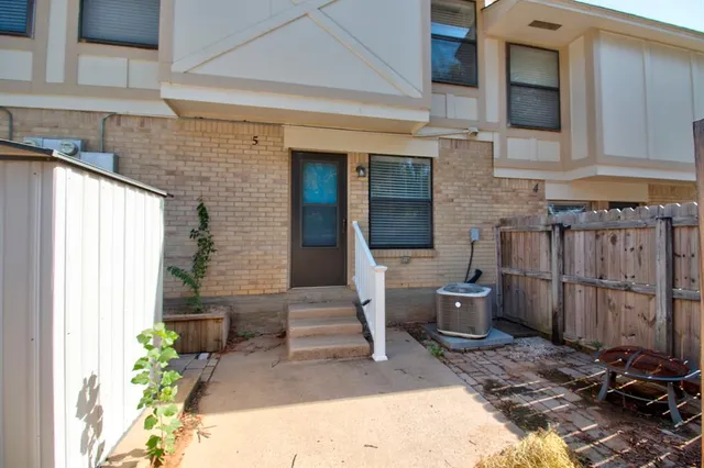 a backyard of a house with outdoor seating