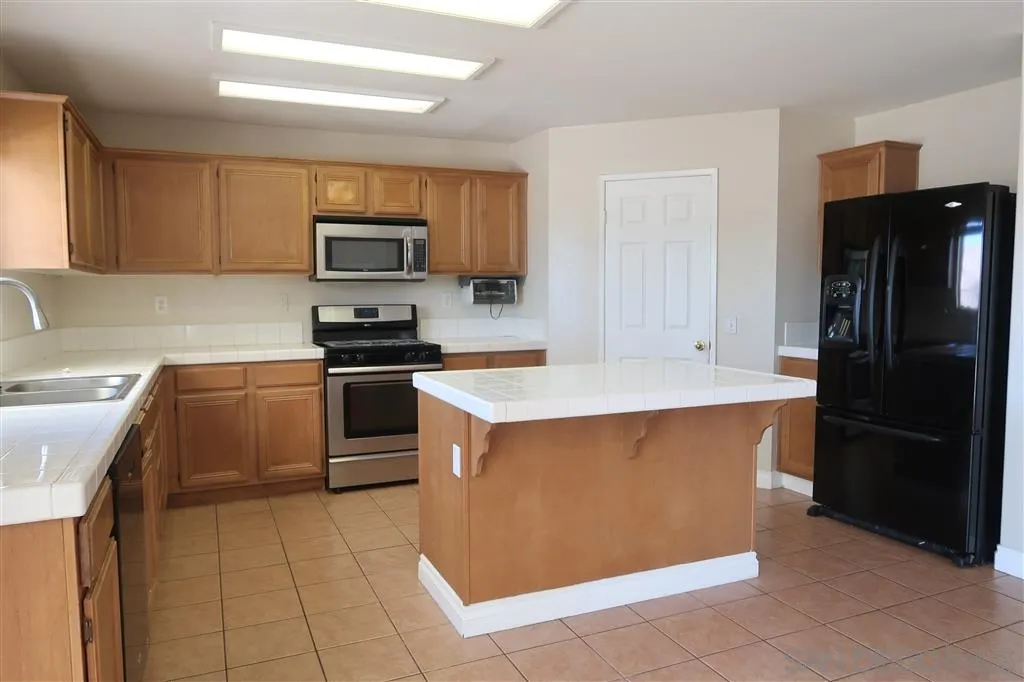 33734 Abbey Road Temecula, CA 92592 - Photo 16 of 25 a kitchen with stainless steel appliances and view of kitchen