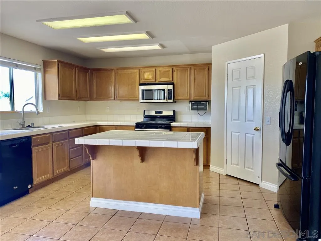 33734 Abbey Road Temecula, CA 92592 - Photo 2 of 25 a kitchen with stainless steel appliances cabinets and a refrigerator