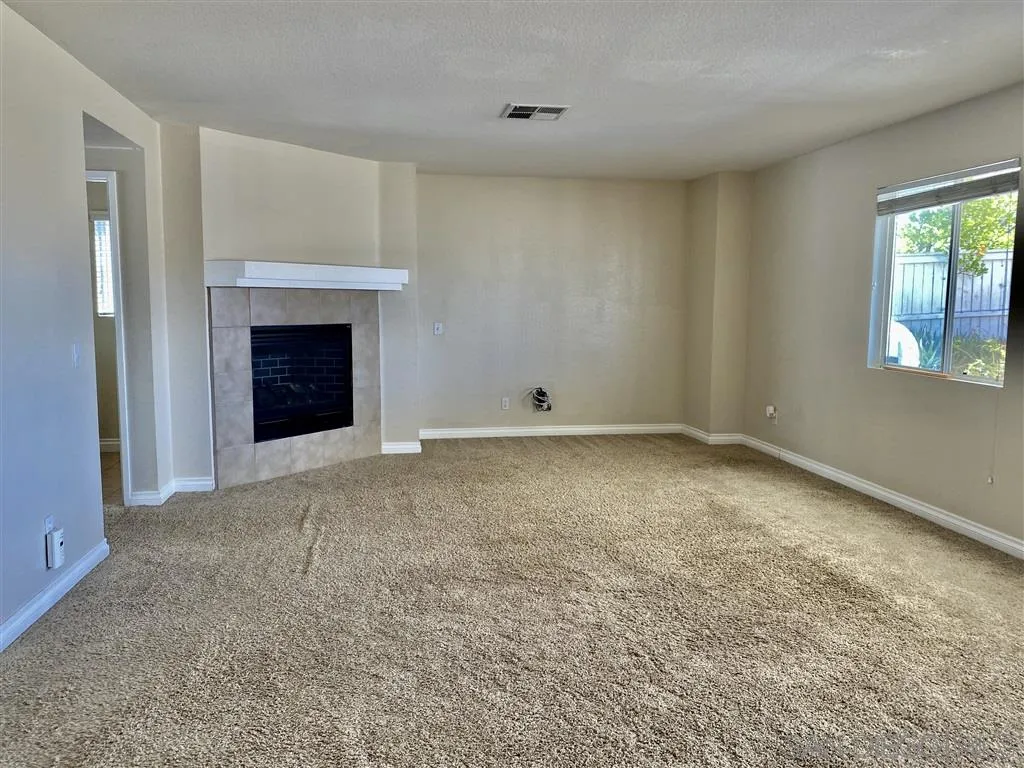 33734 Abbey Road Temecula, CA 92592 - Photo 3 of 25 a view of an empty room with window and fire place