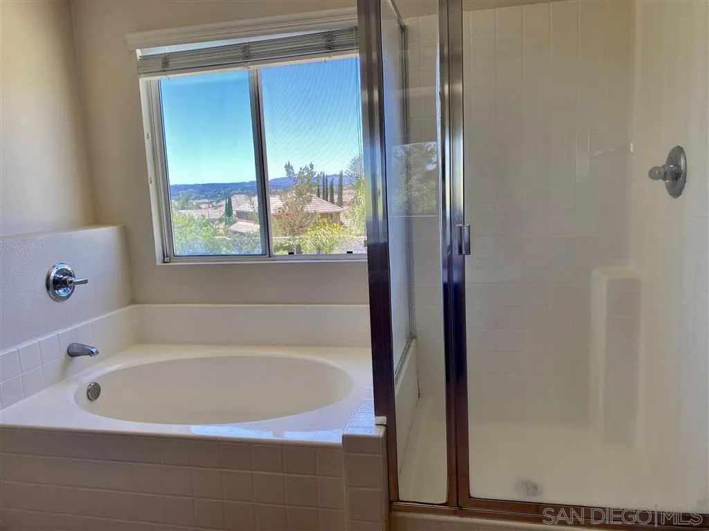 33734 Abbey Road Temecula, CA 92592 - Photo 10 of 25 a white bath tub sitting in a bathroom next to a window