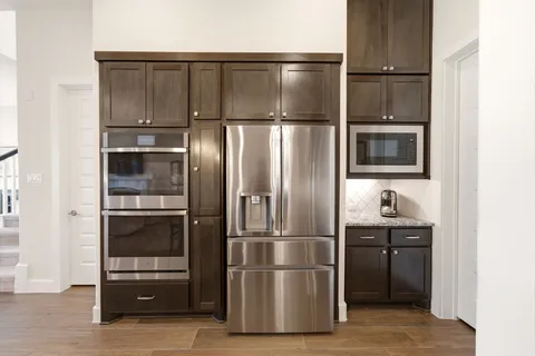 a kitchen with cabinets and stainless steel appliances
