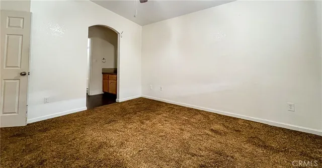 a bathroom with a granite countertop sink toilet and a mirror