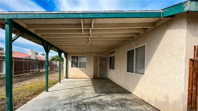 a view of backyard with small cabin and wooden fencing