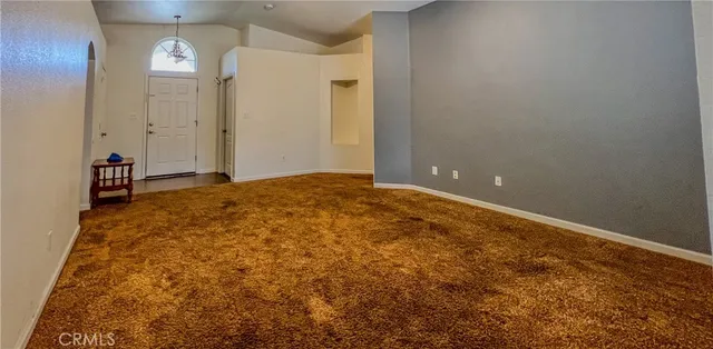 a view of a kitchen with granite countertop wooden floor a sink and a window