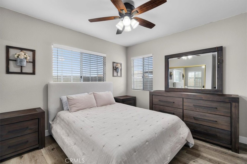 338 East 219th Street Carson, CA 90745 - Photo 14 of 36 a bedroom with a large bed and a chandelier